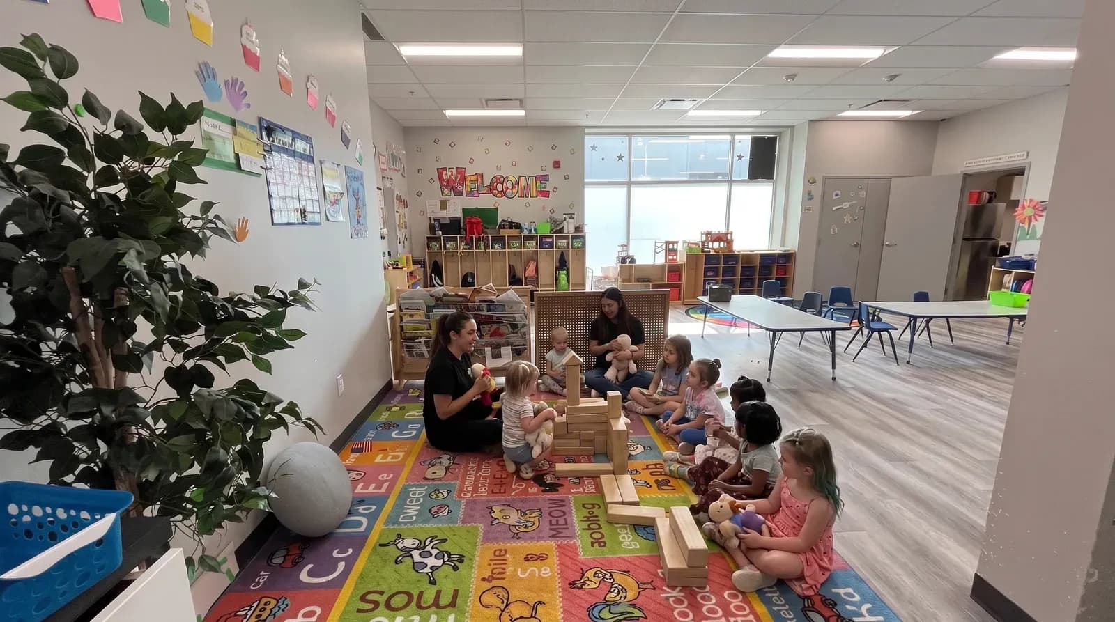 A bright infant room with soft play mats and age-appropriate toys at Playbox Childcare Centre.